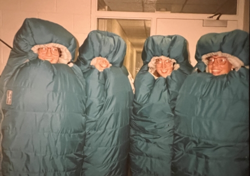 Beth with fellow staff wearing survival sleeping bags which they were forced to buy for the 